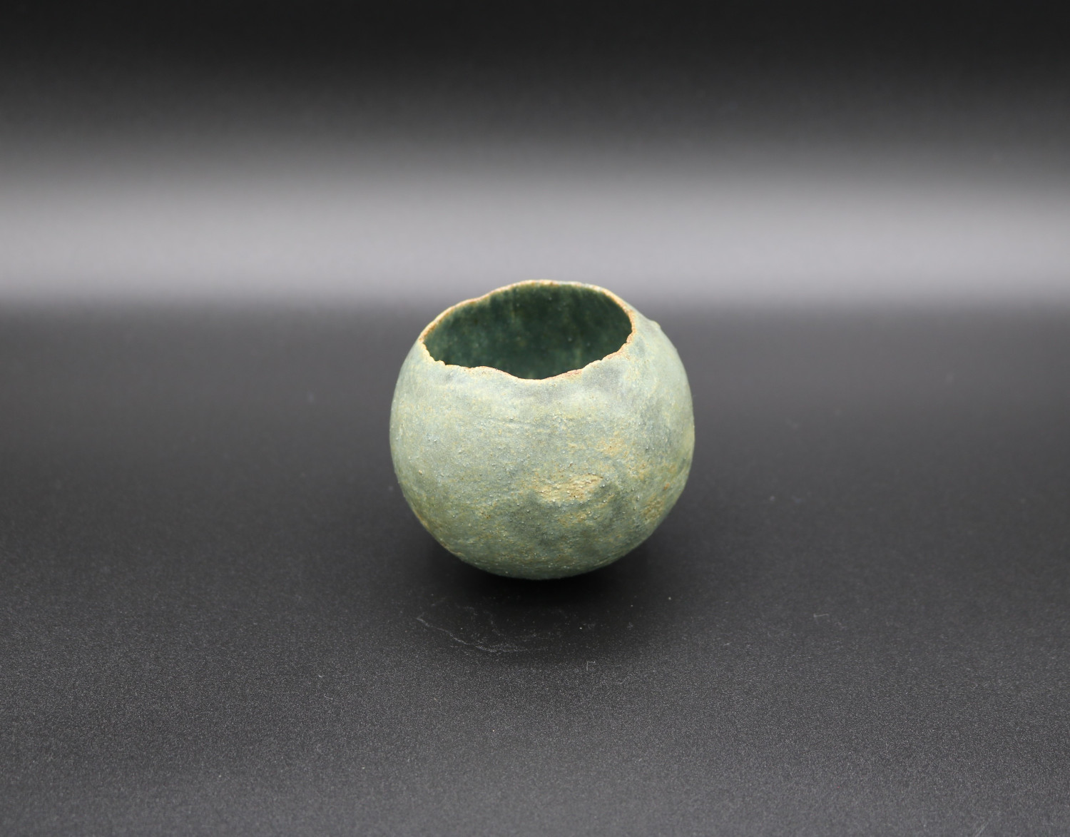 An Early Small Pinch Pot of Spherical Form